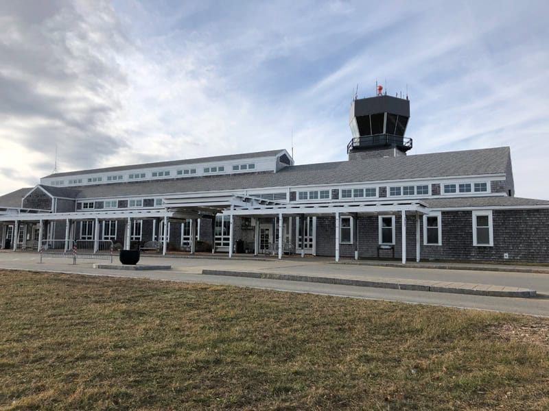 Martha's Vineyard Airport Terminal, featuring a modern design with a control tower and entrance area, located on Martha's Vineyard island.